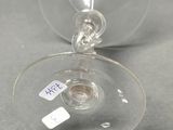 a wine glass with a tag on it sitting on a table
