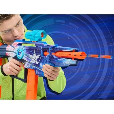 the man is playing with a nerfle gun on a blue background