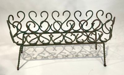 an image of a metal magazine rack with a heart design on it