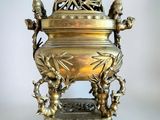 une grande urne en laiton ornée d'oiseaux et de fleurs