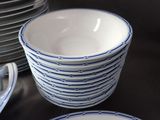 a stack of plates and bowls sitting on a table
