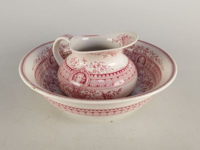a red and white bowl and saucer on a white table