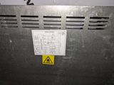 a yellow sticker on the back of a metal box