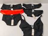 three pieces of underwear are on a table with tags on them