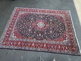 an oriental rug is laying on the ground next to a pair of scissors