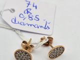 a pair of gold and diamond earrings with a price tag