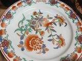 a plate with a floral design on it sitting on a table