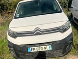 a white van parked next to a white van in a field