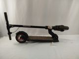 a scooter that is sitting on a white surface