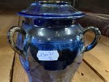 a glass jar with a tag on it sitting on a wooden table