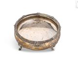 an antique silver plate with ornate design on a white background