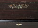 a small wooden box with a floral design on it