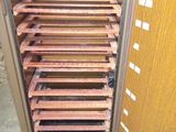 a cabinet that has a bunch of wooden shelves in it