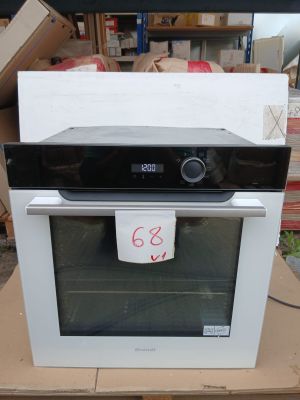 a black and white oven sitting on top of a cardboard box
