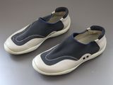 pair of blue and white shoes sitting on top of a gray surface
