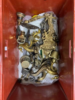 a red box with a bunch of gold items in it
