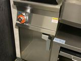 a stainless steel sink in a kitchen with a black door