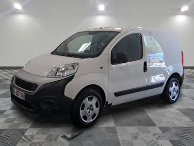 a small white van that is parked in a room