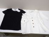 pair of black and white shirts on a table in a room