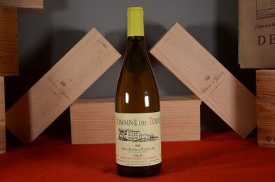 a bottle of wine sitting on a table next to a stack of wooden blocks