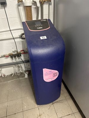 a blue water heater sitting next to a blue refrigerator