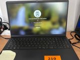 a laptop that is sitting on a desk with a price tag on it