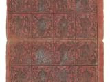 un vieux livre à la couverture rouge, ornée d'un motif représentant des animaux