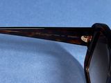 sunglasses on a blue surface with a pair of sunglasses on top of it