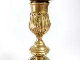 a gold candle holder on a white background
