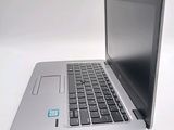 a silver laptop computer sitting on top of a white table