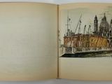 an open book with a drawing of a castle on it