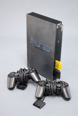 une console de jeux vidéo avec deux manettes à côté