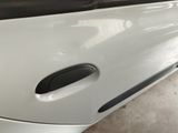 a close up of a door handle on a white car