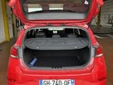 a red car with its trunk open in a garage