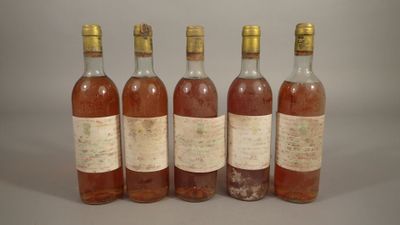 six bottles of wine are lined up in a row