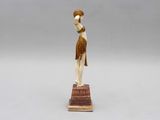 an image of a figurine of a woman with a basket on her head