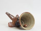 a brown and blue vase with a bird on it