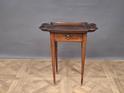 an old wooden table with a drawer on top of it on a parquet floor