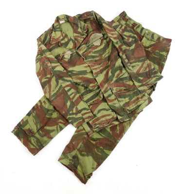 a close up of a camouflage suit on a white surface