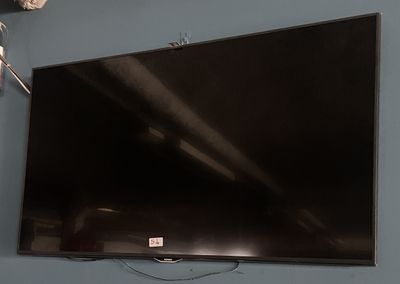 a flat screen tv hanging on a wall in a room