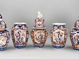 several vases with different designs are lined up against a gray background