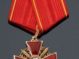 a close up of a medal with a cross on it