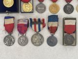 some of the medals and medals have been placed on a white surface