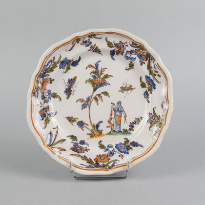 an image of a plate with a bird and flowers on it