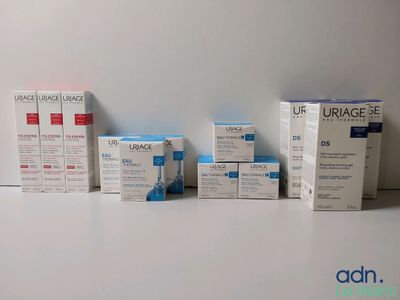 several boxes of urage are lined up on a white surface