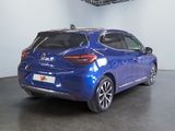 the rear end of a blue car in a showroom
