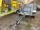 a trailer with a crane attached to it in a field