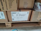 a pile of boxes and a cell phone on the floor