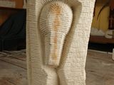 a sculpture of a man ' s head on a wooden table