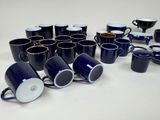 a lot of coffee cups that are sitting on the table